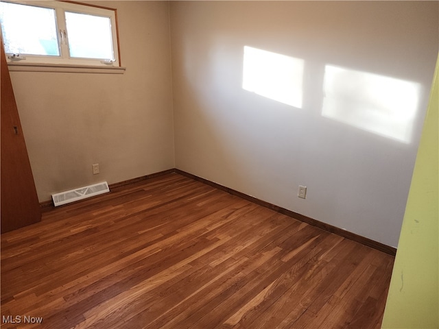 spare room with dark hardwood / wood-style floors