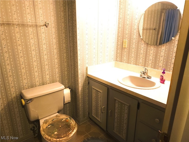 bathroom with vanity, toilet, and tile patterned floors