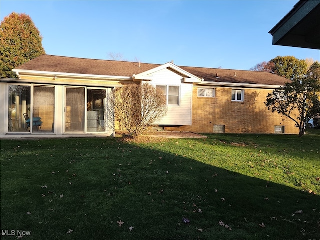 rear view of house with a lawn