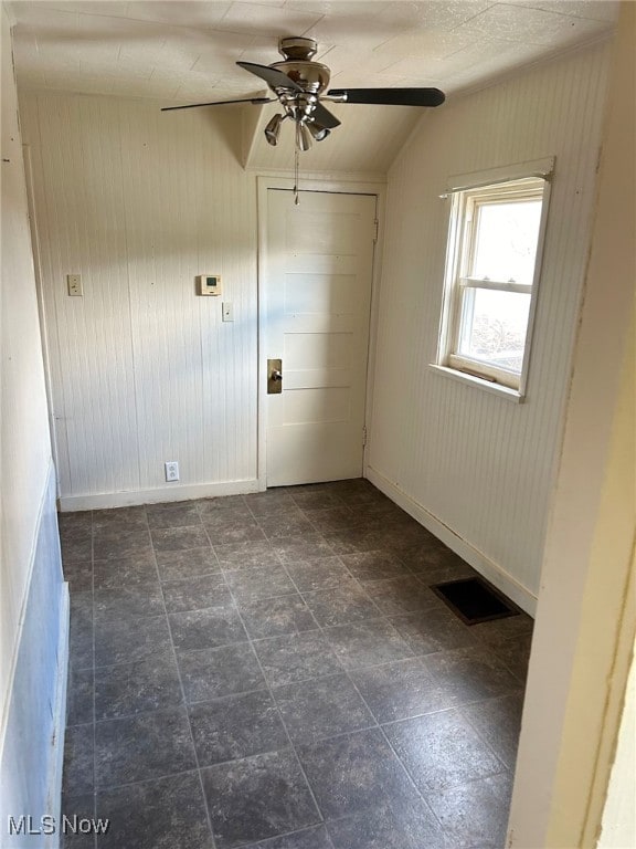 empty room featuring vaulted ceiling and ceiling fan