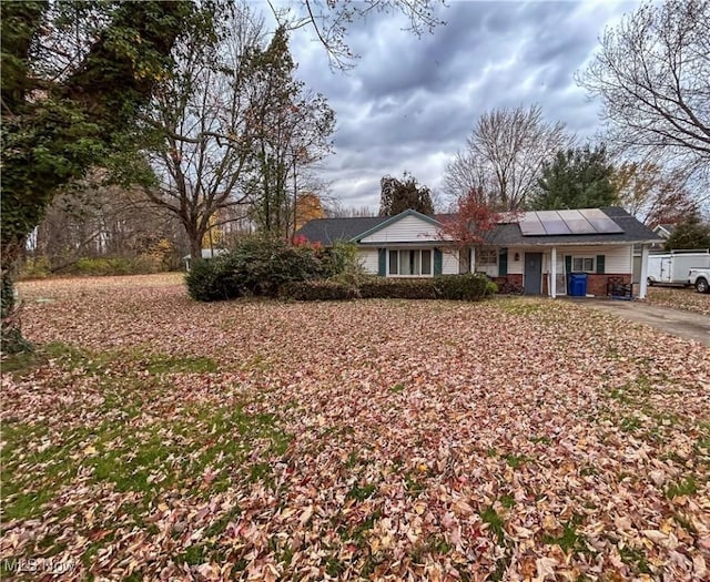 view of front of property featuring solar panels