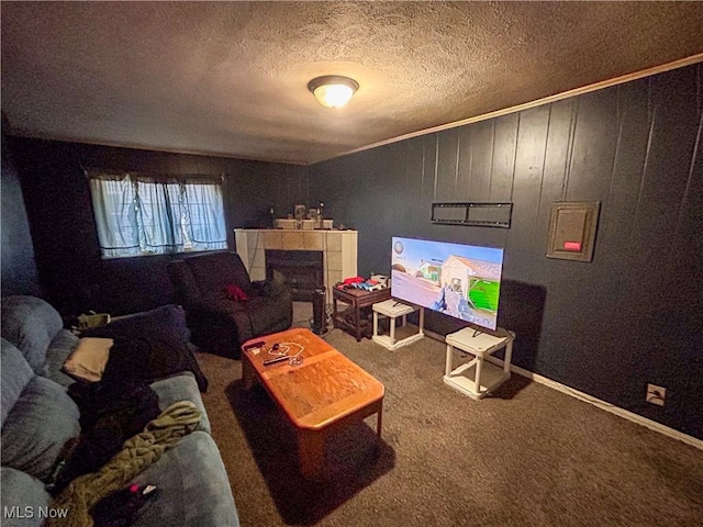 carpeted living room featuring a tile fireplace, a textured ceiling, crown molding, and wooden walls