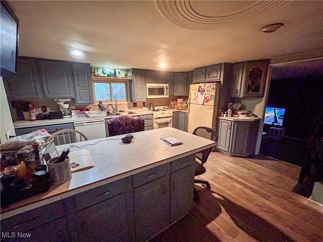 kitchen with light wood-type flooring and white appliances