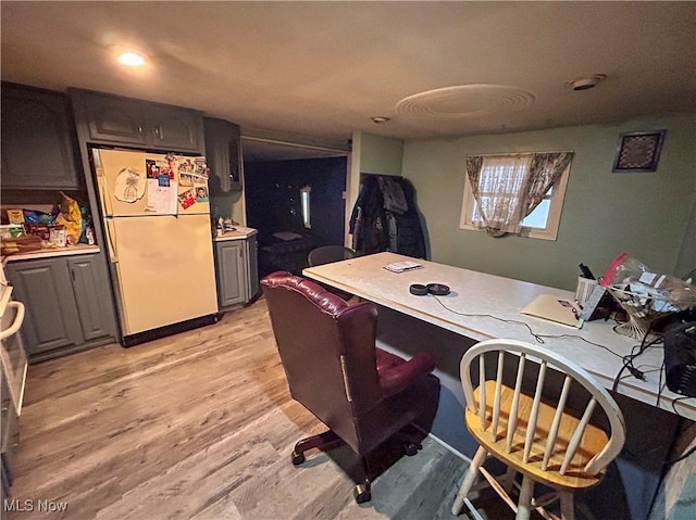 interior space featuring gray cabinetry, refrigerator, and light wood-type flooring