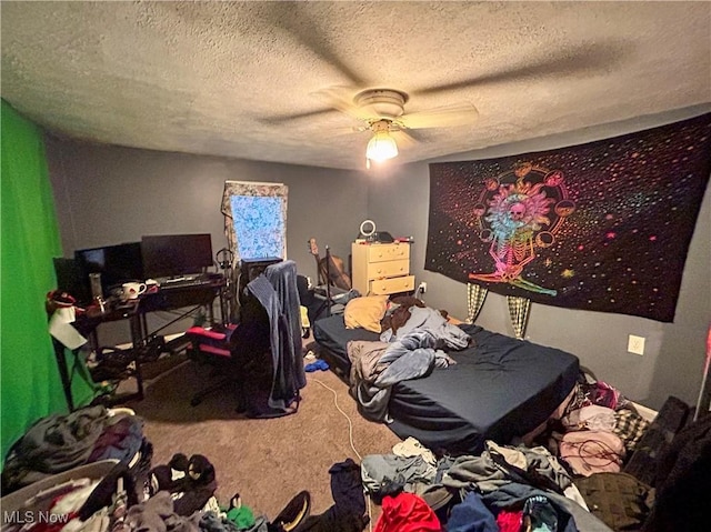 carpeted bedroom featuring ceiling fan and a textured ceiling