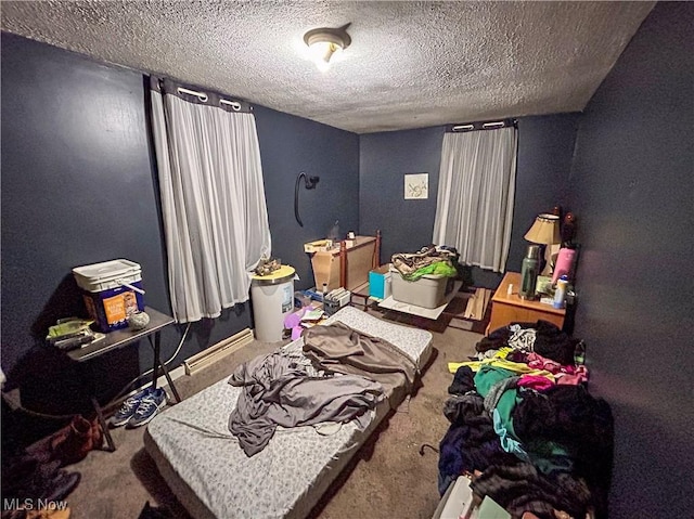 bedroom featuring carpet floors and a textured ceiling