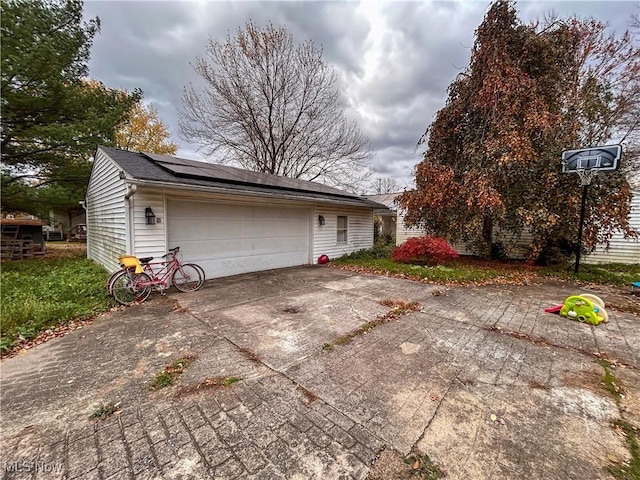 view of front of house featuring solar panels and a garage