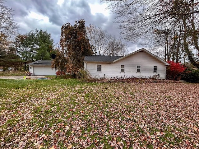 view of side of property with a garage and a yard