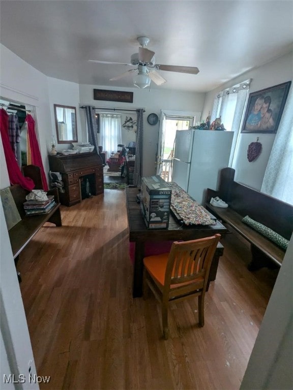 dining space with wood finished floors and ceiling fan