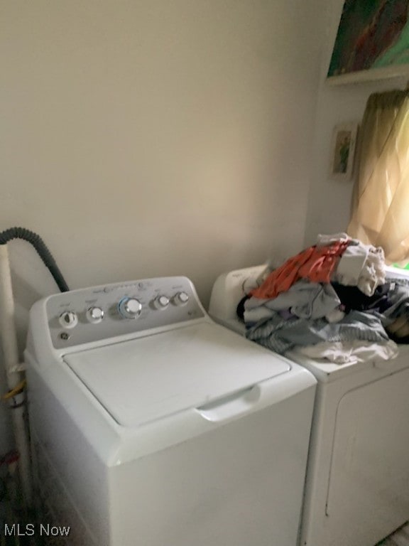 clothes washing area with laundry area and separate washer and dryer