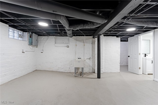 basement with washer / dryer, electric panel, and sink