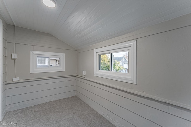 additional living space with wood ceiling, light colored carpet, and vaulted ceiling