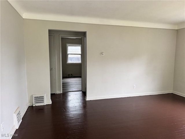 empty room featuring dark hardwood / wood-style flooring