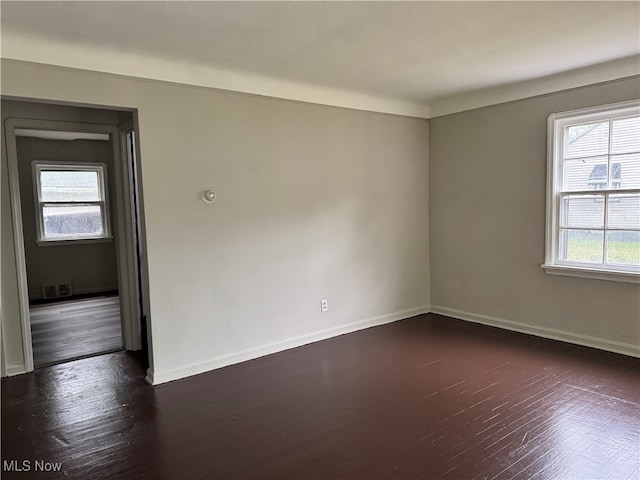 spare room featuring dark wood-type flooring