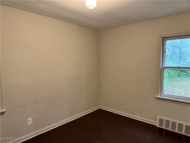 spare room with hardwood / wood-style flooring