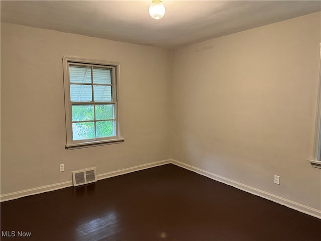 unfurnished room featuring dark hardwood / wood-style flooring