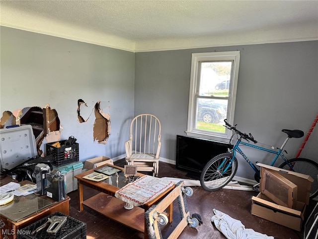 misc room with a textured ceiling and baseboards