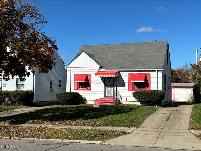 bungalow with a garage and a front lawn