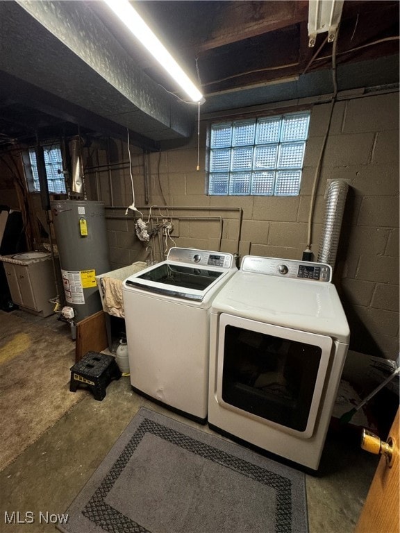 laundry area with gas water heater and washer and dryer