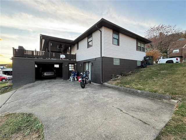 view of side of home featuring a balcony and a lawn