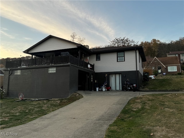 view of front of house with a balcony and a lawn