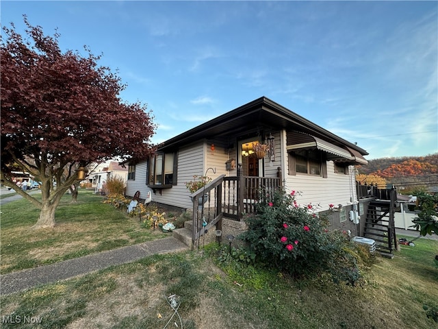 bungalow-style home featuring a front yard