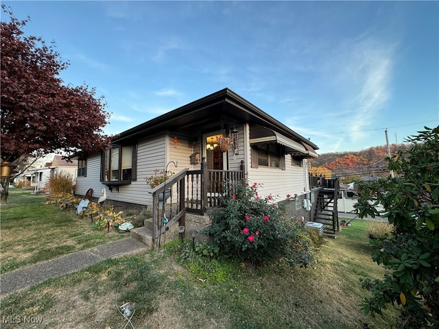 bungalow-style house featuring a front yard