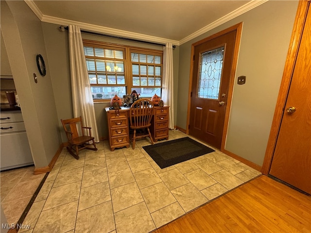 foyer entrance featuring crown molding and light hardwood / wood-style flooring