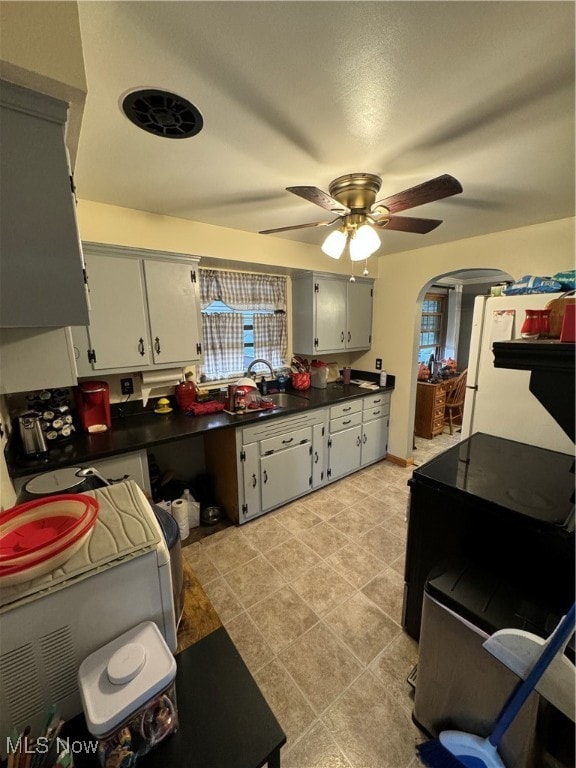 kitchen with sink, ceiling fan, and white refrigerator