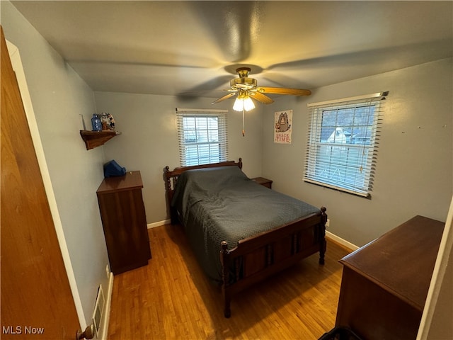 bedroom with ceiling fan and light hardwood / wood-style flooring