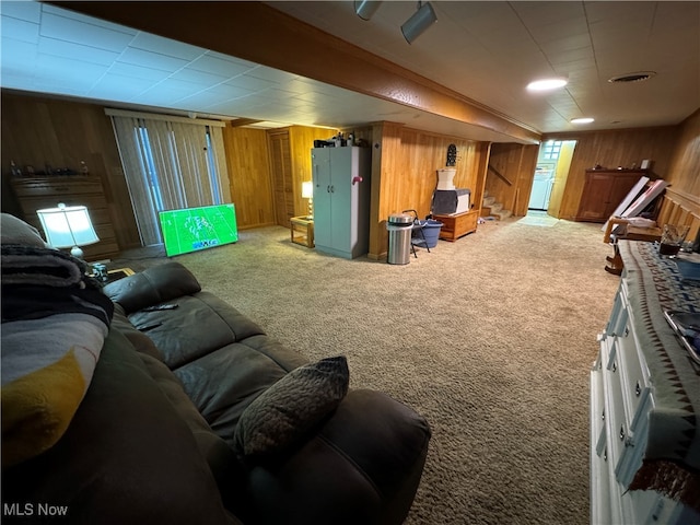 living room featuring carpet floors and wood walls