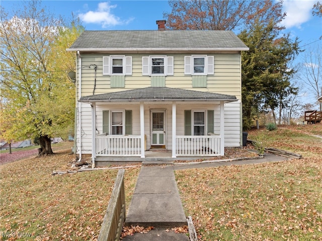 view of front facade with covered porch and a front yard