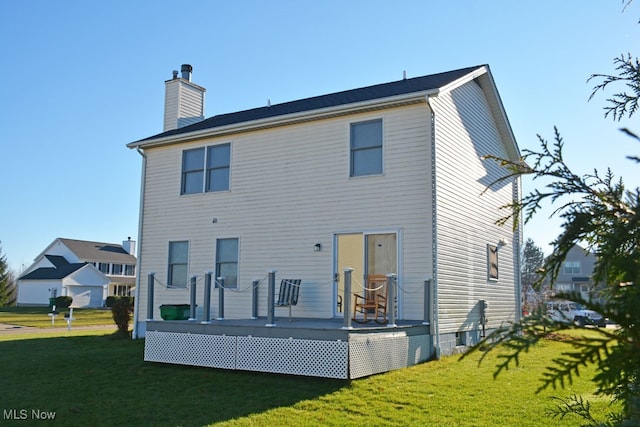 back of property featuring a yard and a deck