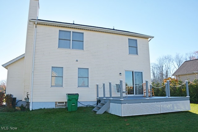 rear view of house with a lawn and a deck