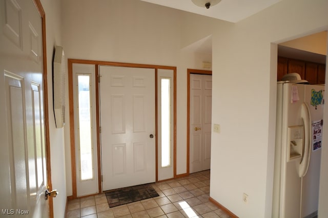 foyer entrance with light tile patterned floors