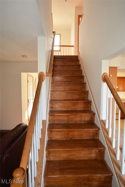 stairway with hardwood / wood-style floors