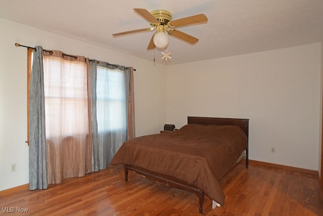 bedroom with hardwood / wood-style flooring and ceiling fan