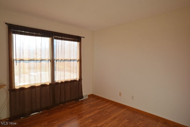 empty room with dark wood-type flooring