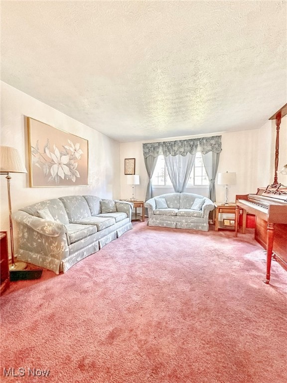 carpeted living room featuring a textured ceiling