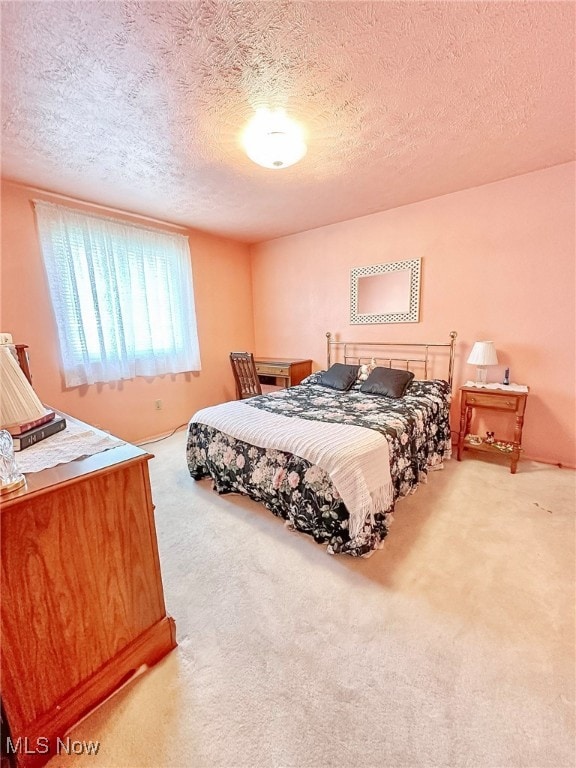 carpeted bedroom featuring a textured ceiling