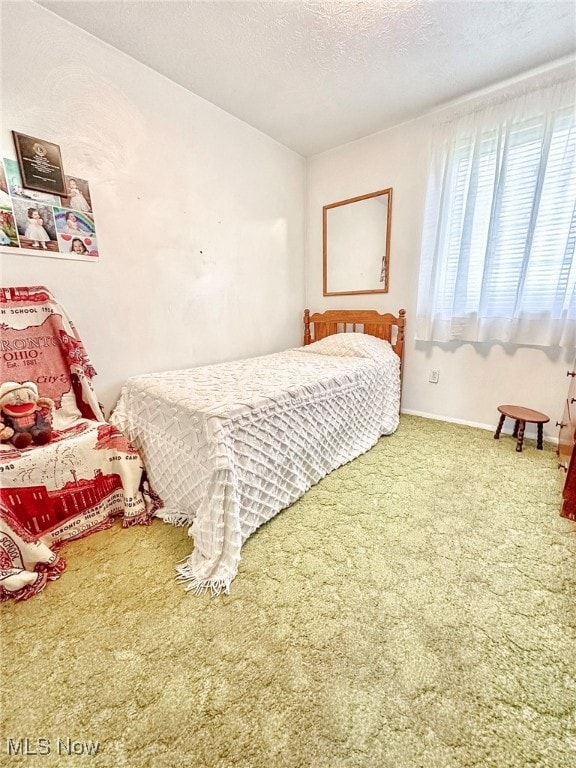 carpeted bedroom featuring a textured ceiling