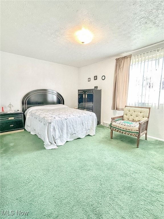 bedroom featuring a textured ceiling and carpet