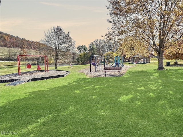 surrounding community with a playground and a yard