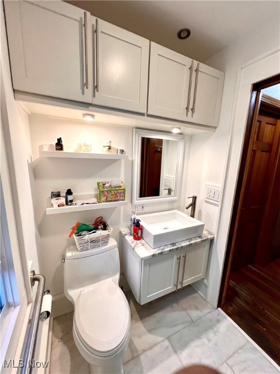 bathroom featuring vanity, toilet, and hardwood / wood-style floors