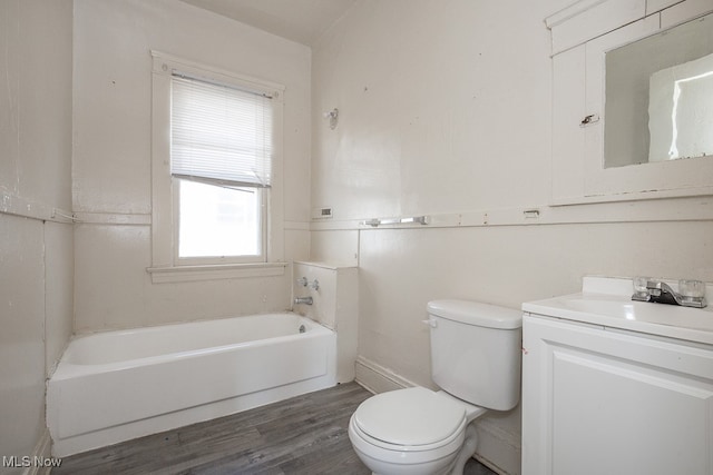 bathroom featuring a bathing tub, toilet, vanity, and wood-type flooring