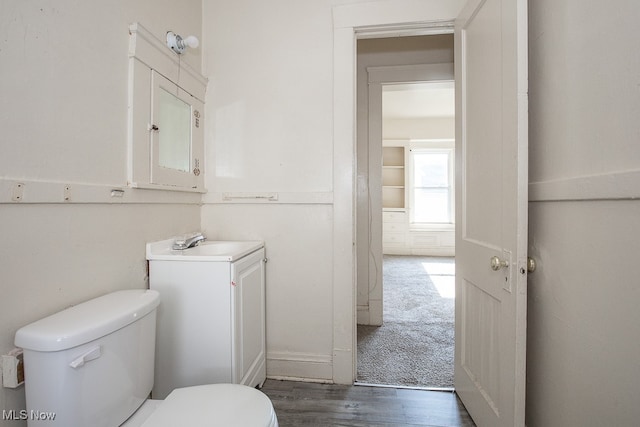 bathroom with sink, wood-type flooring, and toilet