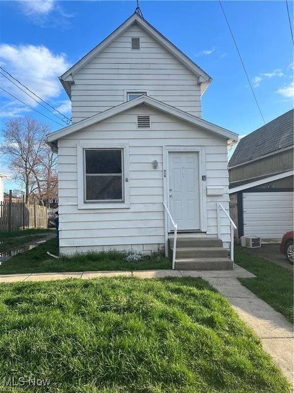 bungalow featuring central air condition unit and a front yard