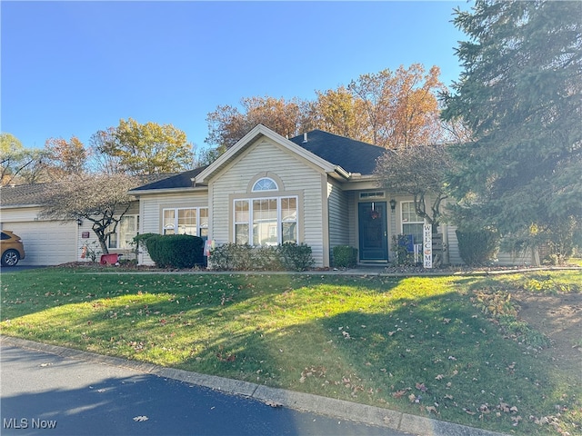 single story home with a garage and a front yard