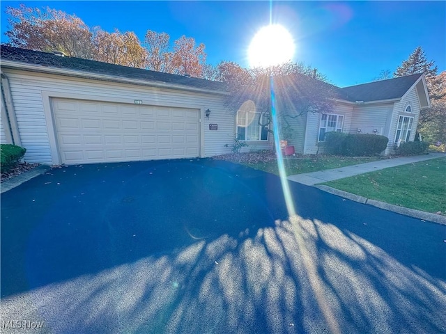 single story home with a garage and driveway