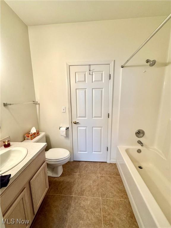 full bathroom with shower / bath combination, vanity, toilet, and tile patterned floors